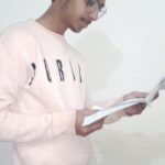 Young male student wearing glasses writing in a notebook at a study desk, alongside a banner titled “Top 10 Benefits of Personalised Study Plans for Students” highlighting key advantages like focused learning, improved performance, and better time management.